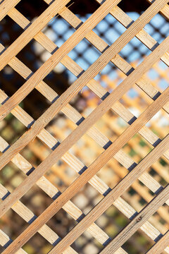 Wooden planks for background on a diagonal. White Lattice with Wooden Background