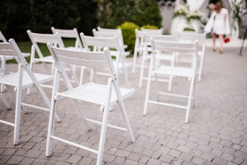 Many white folding chairs