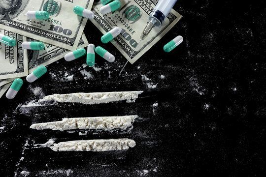 Drug Divided Into Lines, Pills And Dollar Bills On Black