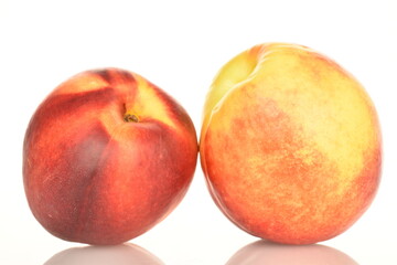 Ripe juicy organic nectarine, macro, on a white background.