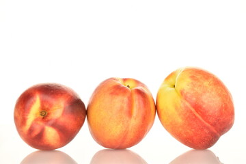 Ripe juicy organic nectarine, macro, on a white background.