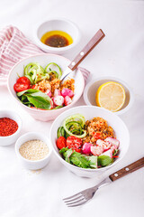 Fresh salad with couscous, tomatoes, cucumber, radish and chard.