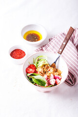 Fresh salad with couscous, tomatoes, cucumber, radish and chard.