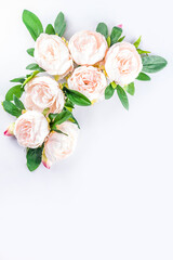 Obraz na płótnie Canvas Floral peonies arrangement . Artificial tender white pinkish peony flower with leaves, flat composition on a light background. top view place for text