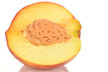 Ripe juicy organic nectarine, macro, on a white background.