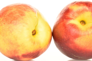 Ripe juicy organic nectarine, macro, on a white background.