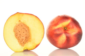 Ripe juicy organic nectarine, macro, on a white background.