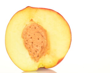 Ripe juicy organic nectarine, macro, on a white background.