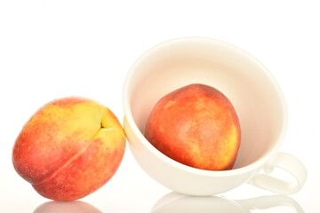 Ripe juicy organic nectarine, macro, on a white background.