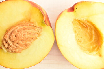 Ripe juicy organic nectarine, close-up, on a painted wooden table.