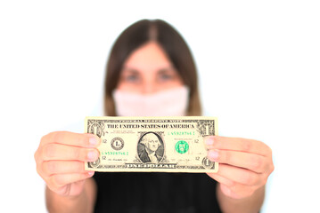 Woman in medical protective mask holding one dollar. Health and hand protection. Coronavirus economy. COVID-19 economic crisis.