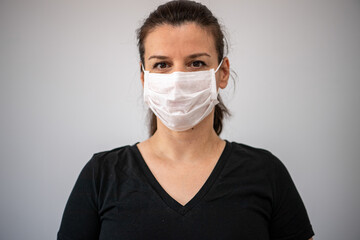 Close up portrait of beautiful young woman cover her face wearing  medical  mask