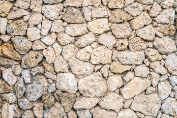 Old stone masonry. Background image of a historical wall. Stone wall from Sandstone.