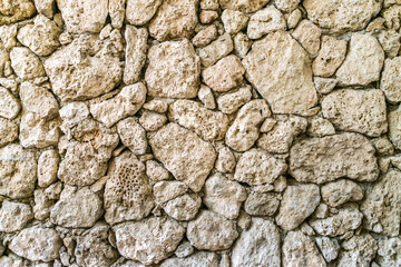 Stone wall from Sandstone. Old stone masonry. Background image of a historical wall.