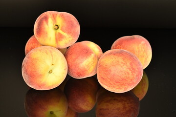 Ripe organic peach, close-up, on a black background
