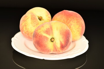 Ripe organic peach, close-up, on a black background