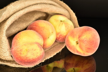 Ripe organic peach, close-up, on a black background