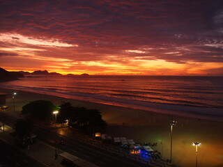 Naklejka na ściany i meble Rio de Janeiro, Brazil - 09/03/2020: Sunrise on the coast of the Atlantic ocean, Copacabana beach