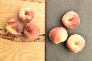 Ripe organic peach, close-up, on a wooden table.