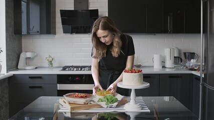 Cooking cake at home. Beautiful white cake with strawberry, Panna Cotta and tiramisu cake on the table