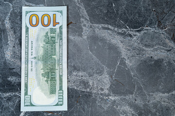 dollars lying on a gray marble table