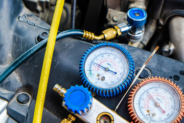 Close up monitor gage tool on car engine for check and fixed car air conditioner system