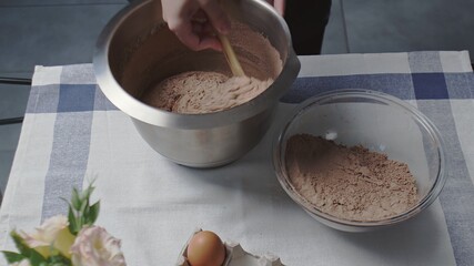 Cooking cake at home. Top view of housewife mixes dough for chocolate cake