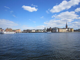 Blue water focus from the ground level with Stockholm old town (Gamla Stan) on background, Landscape of Gamla Stan, Sweden.