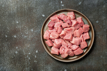 Fresh pork meat on ceramic plate for cooking