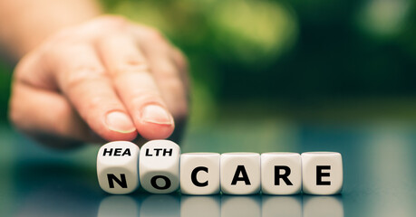 Hand turns dice and changes the expression "no care" to "health care".