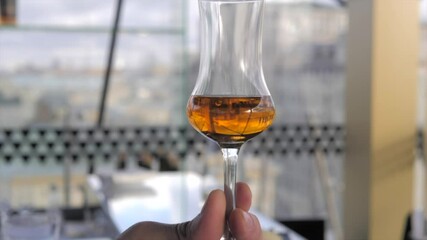 Whiskey in glasses on a thin leg. Cocktail party whiskey tasting