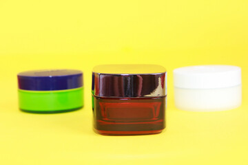 plastic multicolored jars with care cream