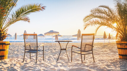 Coastal landscape - view of the beach with beach furniture, palm trees and umbrellas, city of Varna, on the Black Sea coast of Bulgaria