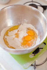 Eggs and flour in metal bowl