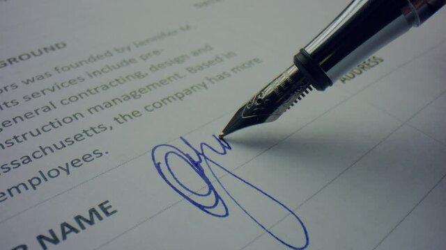 Unknown person signing document with pen. Worker using nibbed fountain pen