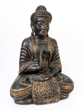 Close-up of Buddha statue sitting in meditation isolated on white background