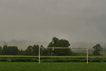 Abandoned rural football field in the fog.