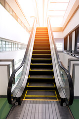 Single escalator for customer service in public building with lighting effect.