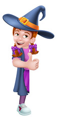 A kid cartoon girl child dressed in a witch Halloween costume peeking around a sign and giving a thumbs up