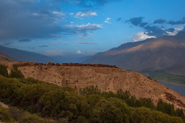 Fototapeta premium Central Asia. Tajikistan. Remains of an ancient dilapidated fortress on the Bank of the border river Panj near the village of Yamchun.