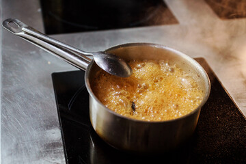 Broth is boiling in the pot on the induction cooker. the process of soup cooking. 