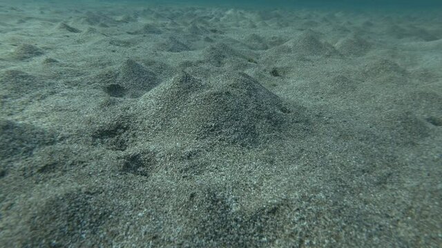An underground source of fresh water comes out from the sandy seabed and mixes with sea water. Mediterranean Sea, Rhodes island, Greece