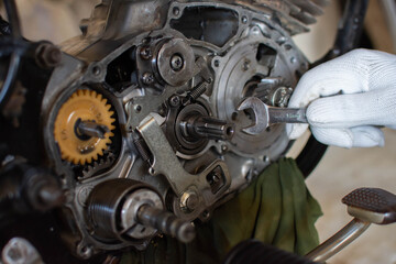 Mechanic uses a motorcycle engine repair machine