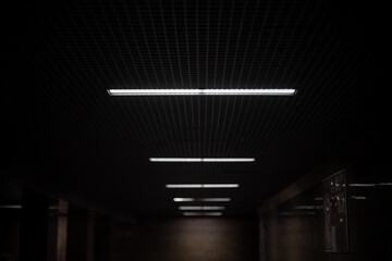 Lamps along the tunnel. Underground passage at night in the city. Space for inserting text. Copy...