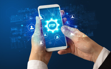 Female hand holding smartphone with FTP abbreviation, modern technology concept