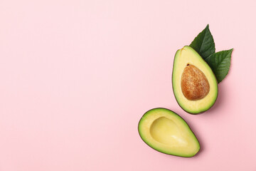 Ripe fresh avocado on pink background, top view