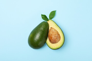Ripe fresh avocado on blue background, top view