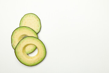 Ripe fresh avocado slices on white background