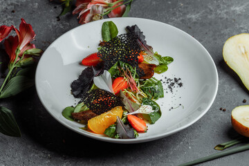 Salad with duck breast. Su-view duck fried in Teriyaki sauce, caramelized pear, tomatoes, salad mix, citrus sauce. copyright place
