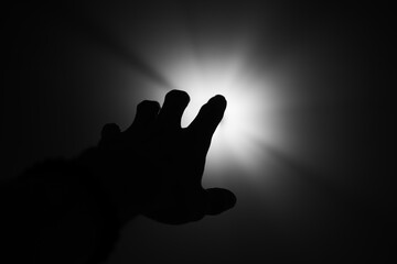 Hand finger silhouette hope help grab light  black and white